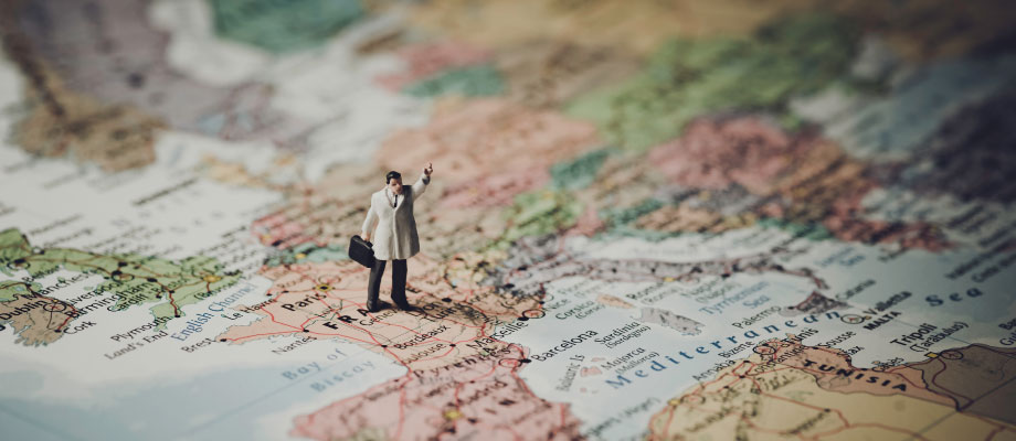 figurine of a man with a suitcase on top of a map