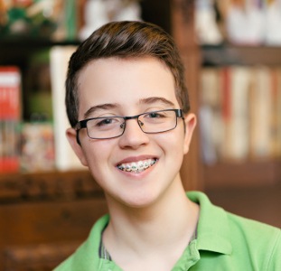 teenage boy with braces smiling
