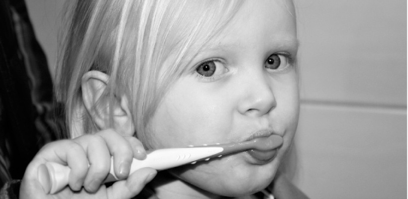 young girl brushing her teeth