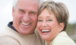 senior couple smiling and laughing after learning about same day crowns