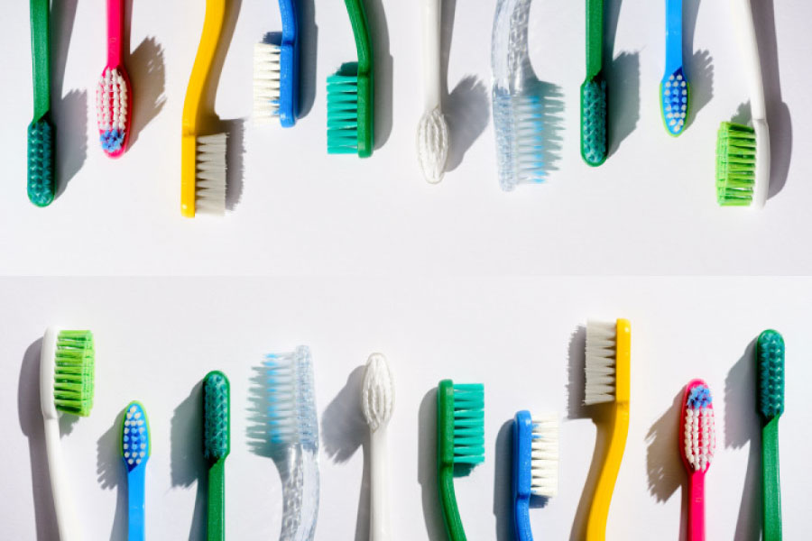 Rows of multicolored toothbrushes.