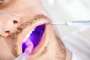 Photo of a patient receiving an oral cancer screening.