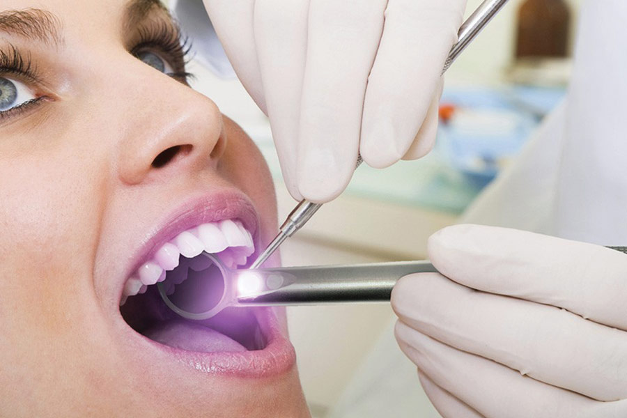 Woman in the dental chair for a preventive exam and oral cancer screening.