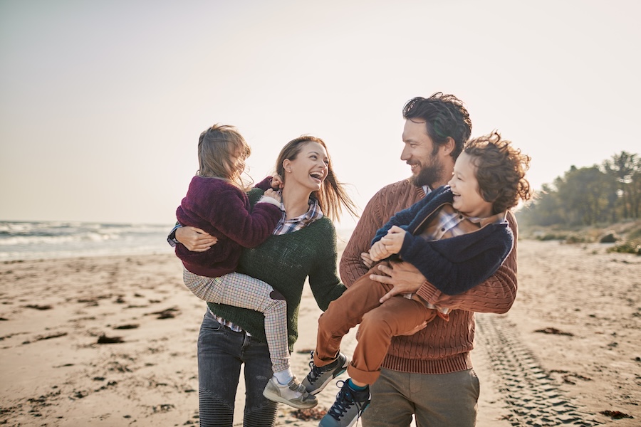 choose a family dentist, young family on the beach